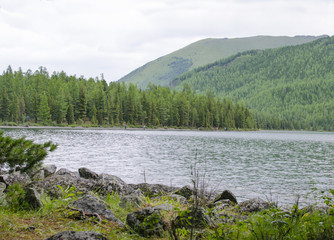 Beautiful landscape of the lake among mountains and the wood