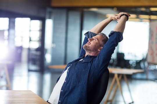 Relaxed Man Sitting In Office