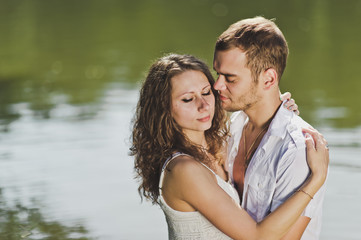 Young guy and girl hugging on nature background 6322.