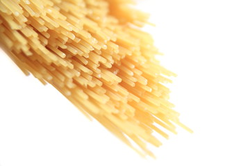 Close up of dry spaghetti on a bright backround with shallow focus