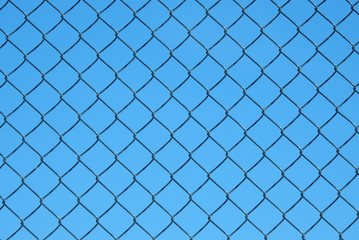 Chain-link fence against blue sky
