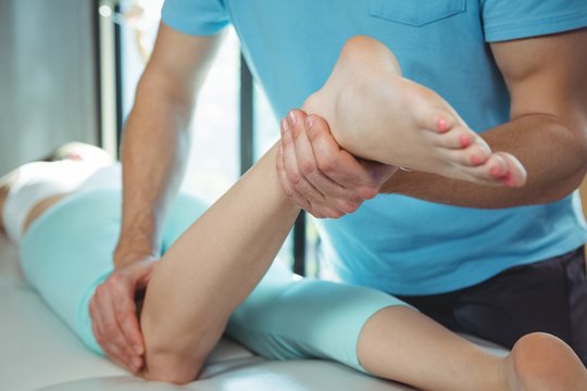 Physiotherapist giving physical therapy 