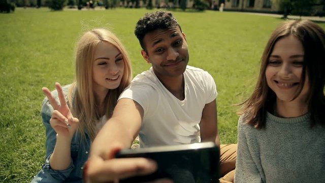 Closeup three student in the park making selfies