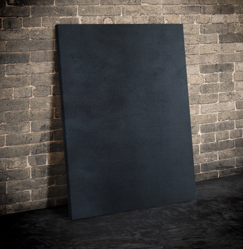 Blank black fabric poster on the grunge brick wall and black cem