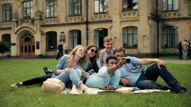 Group of diverse students making selfies outdoor