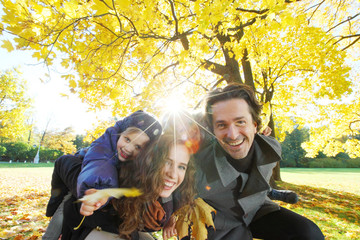 Happy family in autumn park