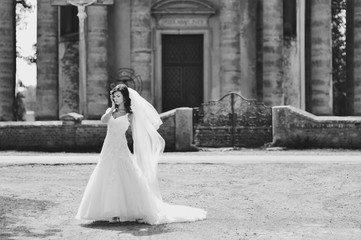 Bride walking next to old church