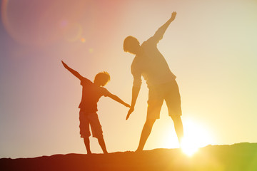 father and son having fun on sunset