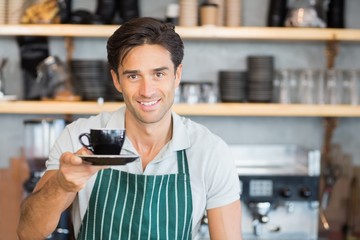 Waiter offering a cup of coffee