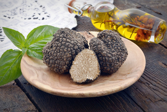 fresh  black  mushroom truffle on a wooden plate