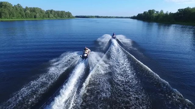 Guys ride on Jet Ski
