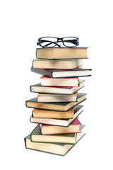 glasses lying on a pile of books. white background - vertical ph