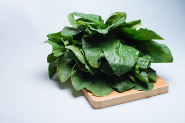 Closeup Fresh harvested spinach on a wooden table.