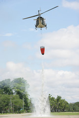 Fototapeta na wymiar Helicopter dropping massive water from bambi bucket.