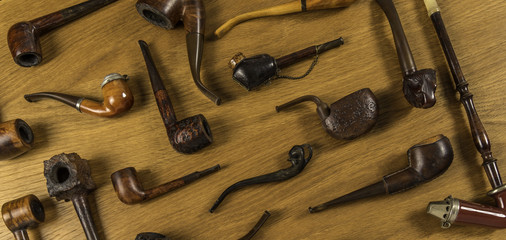 Vintage tobacco pipe set on wooden background