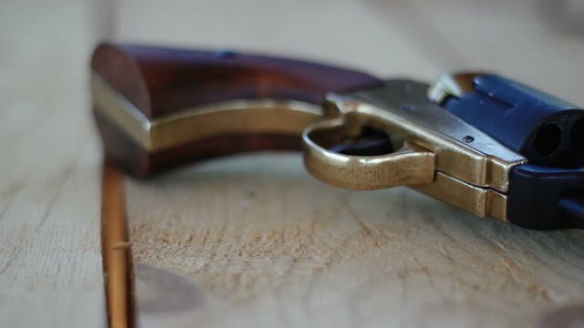 Duplicate of the Colt Peacemaker lying on a wooden table, the legendary American gun during the civil war.