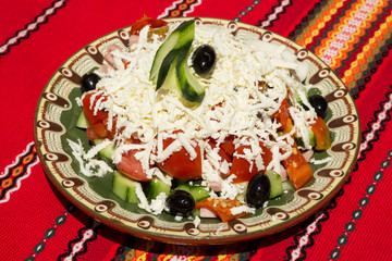 Salad with tomatoes, cucumber, paprika, black olives, cheese and ham