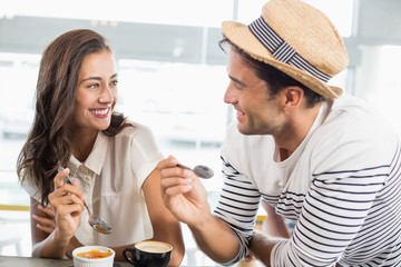 Smiling couple having dessert
