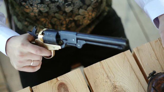 Preparing for the shot, a platoon of trigger of his revolver. Weapons of the civil war.