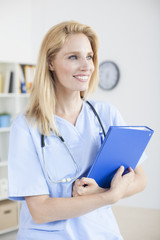 Young female doctor and practitioner working at desk
