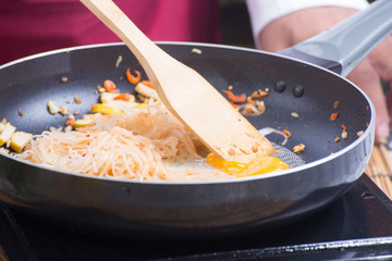 Chef stitr fried rice noodle for cooking Pad Thai