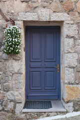 Fototapeta na wymiar Old wooden door in the entrance stone French house