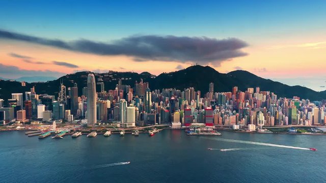 Sunset over Hong Kong island time lapse. Urban cityscape 4K panorama background