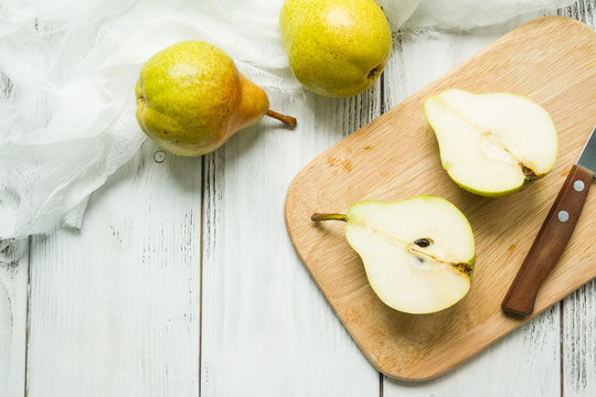 Fresh ripe pears on a white wooden planks