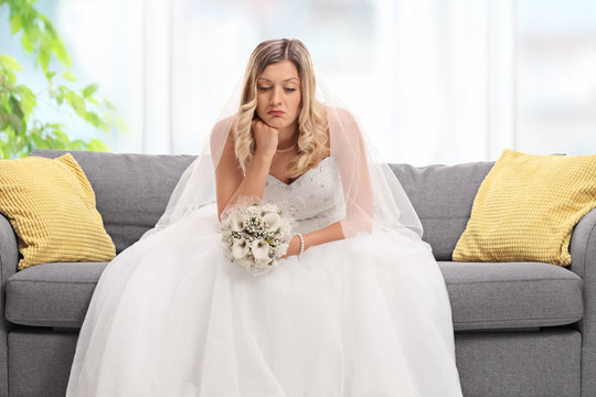 Depressed bride sitting on a sofa