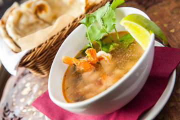 Spicy soup with prawns in cafe