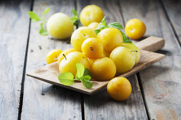 Summer sweet yellow plums on the wooden table