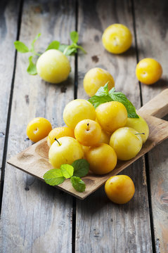 Summer sweet yellow plums on the wooden table