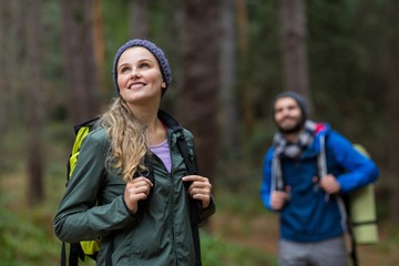 Beautiful woman looking at nature while hiking in forest
