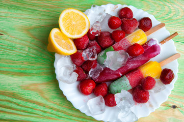Fruit ice cream and fresh fruits, on a wooden abstract backgroun