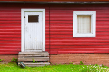 White closed door and window in red wall