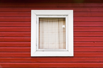 Fototapeta na wymiar Red wooden wall with small window