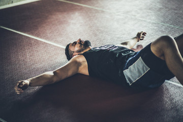 Man tired after the exercising in the gym.