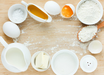 Ingredients for baking - flour, eggs, salt, sugar, butter, milk
