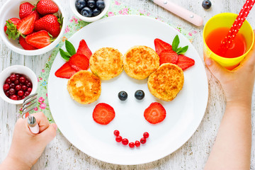 Child eating breakfast concept. Fun food for kids