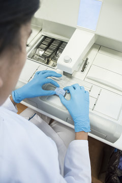 Laboratory technician in analytical laboratory preparing paraffin mold