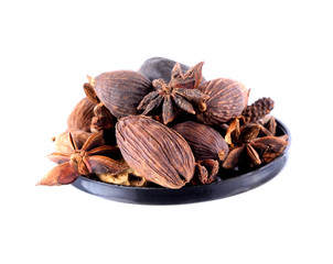 Nutmeg,Star anise spice fruots and seeds in basket on white back