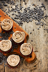 Chocolate cupcakes decorated with close up rose piping icing