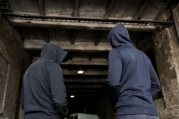 Foto op Canvas addict men or criminals in hoodies on street © Syda Productions