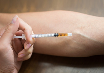 close up of addict hand making drug injection