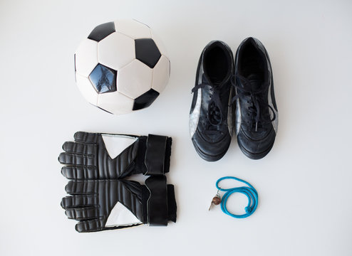 close up of soccer ball, gloves, whistle and boots