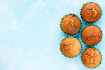 Baking food background blue color with traditional muffins