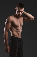 Fototapeta na wymiar Healthy muscular young man posing. Sport portrait.