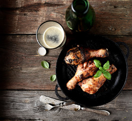 fried chicken legs in a pan. rustic style