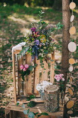 Fototapeta na wymiar arch for the wedding ceremony of burlap and wooden logs in pine