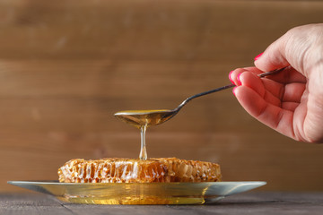 honey dipping on honeycomb